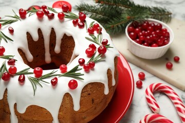 Composition with traditional homemade Christmas cake on white marble table, closeup