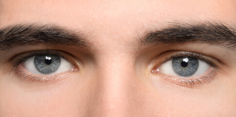 Closeup view of man with beautiful eyes. Banner design
