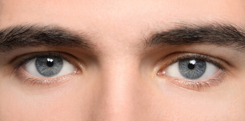 Fototapeta premium Closeup view of man with beautiful eyes. Banner design