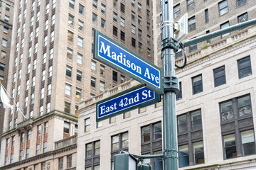 New York City, USA - August 22, 2022: The Madison Ave and East 42nd St street signs are shown in Manhattan, New York City, USA. 