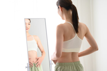 Women who are concerned about their waist in their diet - obrazy, fototapety, plakaty