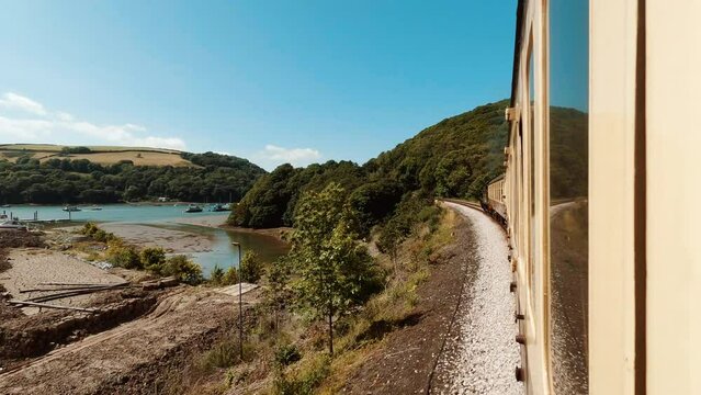 Travelling by steam train along the quintessential South Devon coast in England, UK, a popular summer resort in the country