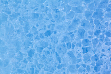 Texture of winter ice surface. Blue natural ice background