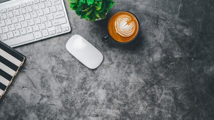 Top view, Dark Office desk with keyboard computer, cup of coffee, mouse and notebook, copy space, Mock up....