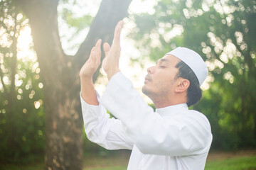 Young asian muslim man praying 