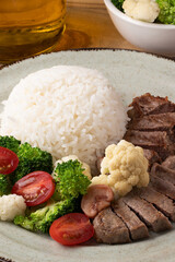 Fresh tenderloin beef served with rice and salad.