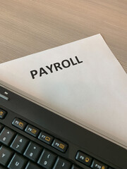 View of keyboard and payroll paper.
