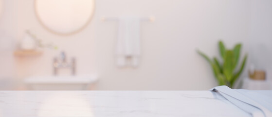 Copy space for montage on modern marble white tabletop over blurred bathroom in the background