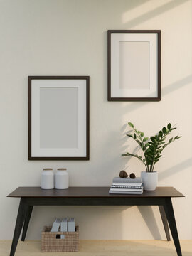 Picture frame mockup on white wall over minimal dark wood table with decors