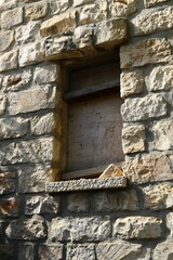 A small window on the facade of a large residential building.