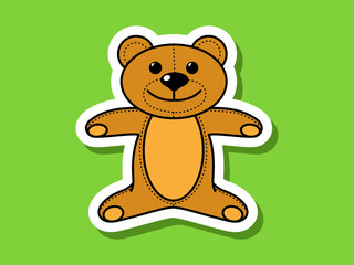 Children's sticker teddy bear on a green background.
