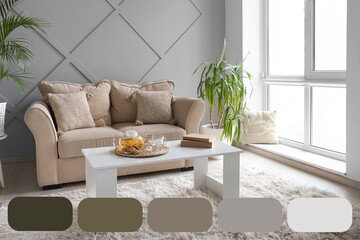 Cozy sofa and table in stylish interior of living room. Different color patterns