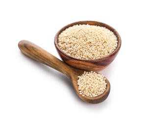 Wooden bowl and spoon with sesame seeds on white background