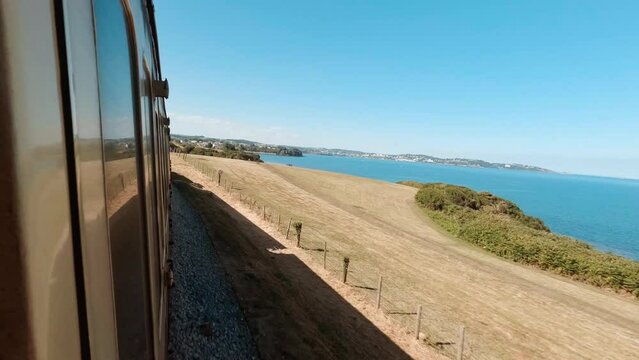 Travelling by steam train along the quintessential South Devon coast in England, UK, a popular summer resort in the country