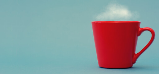 Red coffee mug on blue