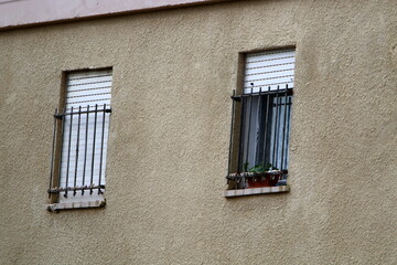 A small window on the facade of a large residential building.