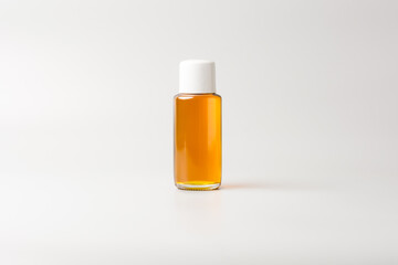 small oil bottle with white cap, mock-up template, isolated on gray background
