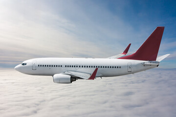 Passenger airliner flies in the air above the clouds