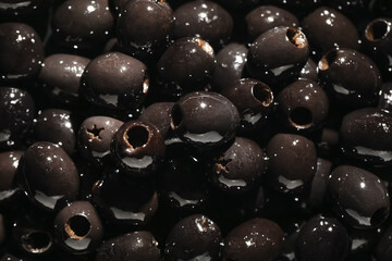 Texture of delicious black olives as background, closeup