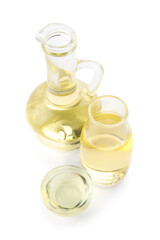 Glass decanter, bottle and bowl with sunflower oil on white background