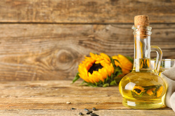 Decanter of sunflower oil on wooden table