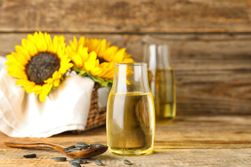 Bottle with sunflower oil on wooden table