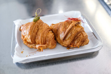 Freshly baked croissants on the tray, brunch at coffee shop.