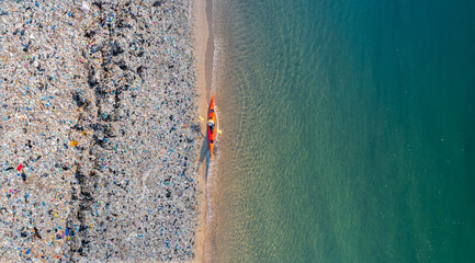 Concept pollution garbage plastic ocean. Aerial top view Kayak boat turquoise blue water sea