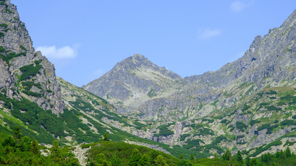 Naklejka na ściany i meble Hot summer day. Mountain landscape with the huge rocky slopes of the High Tatras, Slovakia