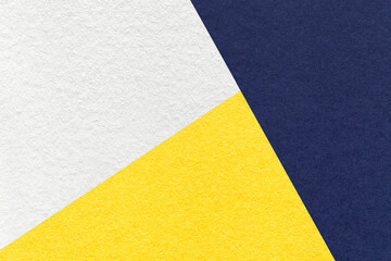 Texture of craft navy blue, white and yellow shade color paper background, macro. Vintage abstract indigo cardboard