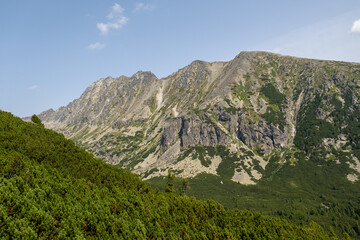 Naklejka na ściany i meble Hot summer day. Mountain landscape with the huge rocky slopes of the High Tatras, Slovakia