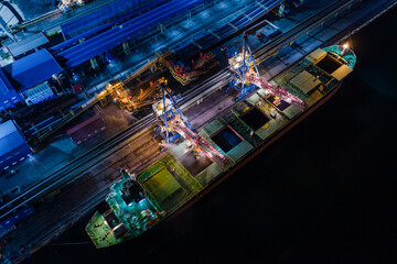 Closed loading of coal on a large cargo ship at a modern coal terminal