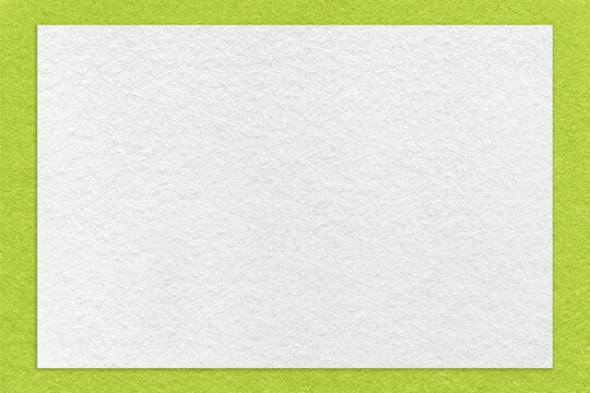 Texture of craft white color paper background with green border, macro. Structure of vintage dense kraft cardboard