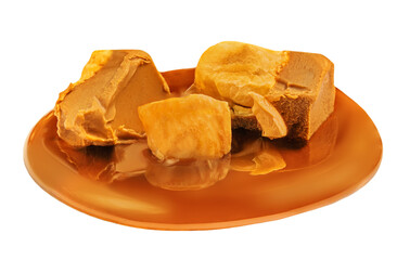 Caramel candies with  sauce isolated on a white background close up. Crushed caramel Pieces
