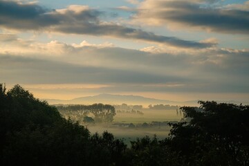 Rural Waikato, New Zealand. Beautiful warm sunrise with hills and paddocks.