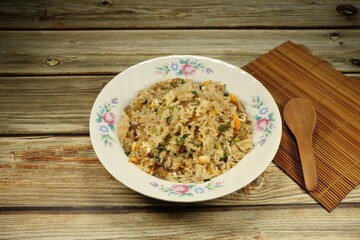 Traditional fried rice mixed with egg and chicken serving on the plate. Famous street food menu in Asia.
