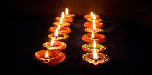 Diwali, Deepavali Hindu festival of lights. Diya lamp lit on black, close up