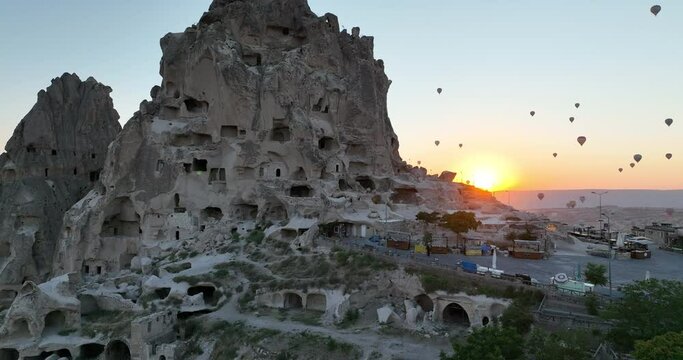 Aerial cinematic drone view of colorful hot air balloon flying over Cappadocia