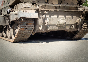 Fototapeta na wymiar Fragment of caterpillar wheels of a military tank