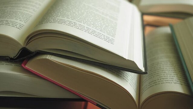 Pile of open books Slider Shot Left to Right