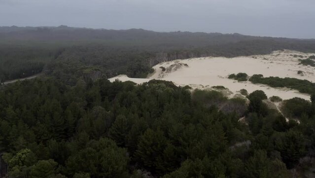 Aerial: Drone flying towards a sand dune on the west coast of Tasmania near Strahan