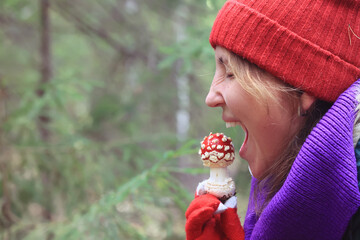 person fly agaric, woman holding fly agaric, dangerous poisonous mushroom, eating herbal medicine