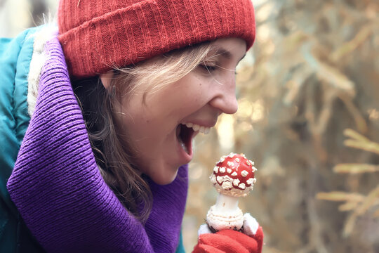 person fly agaric, woman holding fly agaric, dangerous poisonous mushroom, eating herbal medicine