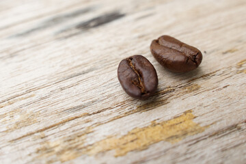 Coffee beans fall on rustic wooden table  Delicious luxury coffee beans and the aroma of morning coffee.