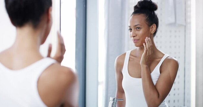 Beauty, face and woman with her health skincare looking at reflection on bathroom mirror in wellness portrait. Healthy, facial and young person doing cosmetic hygiene selfcare morning routine at home