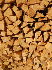 stacked chopped wood logs. Pile of wood logs ready for winter. Wooden stumps, firewood stacked in heap, alternative energy concept,