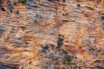 Orange and violet texture of the rock cut. Abstract nature backgrounds