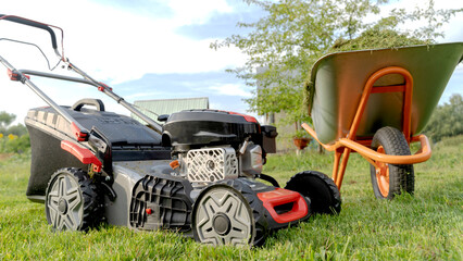 Lawn mover on green grass in modern garden. Machine for cutting lawns.