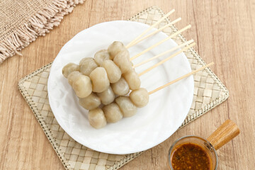 Fototapeta na wymiar Cilok, traditional food from West Java, Indonesia, made from tapioca, chewy textured. Served with peanut sauce. 