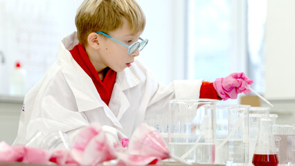 a student in a chemical laboratory conducts chemical sweats with chemical elements